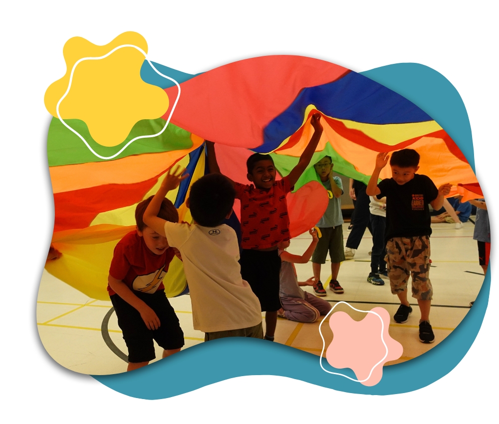 Kids playing with a parachute at summer camp